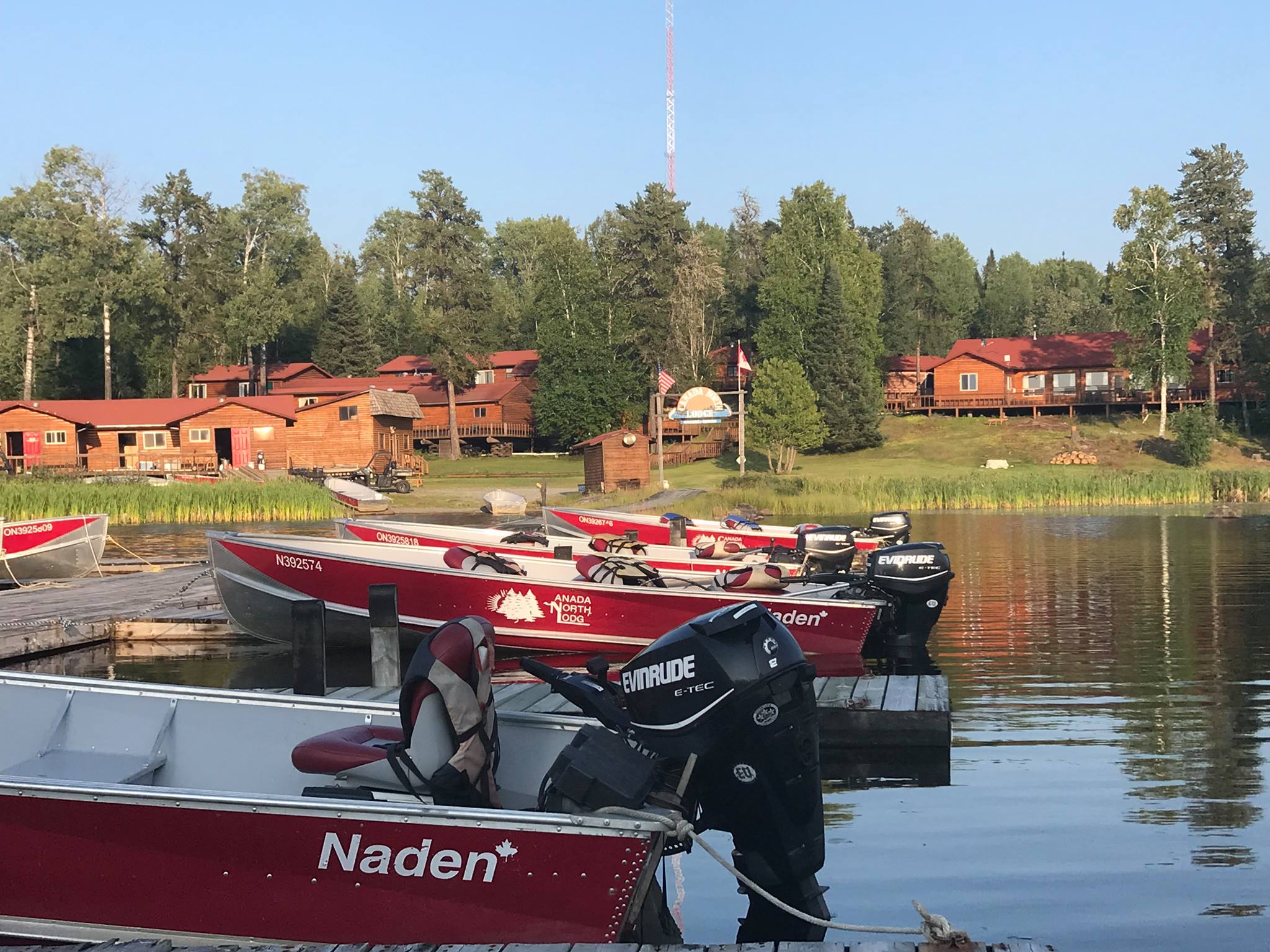 Lodge and red boats on Little Bear Lake at sunrise